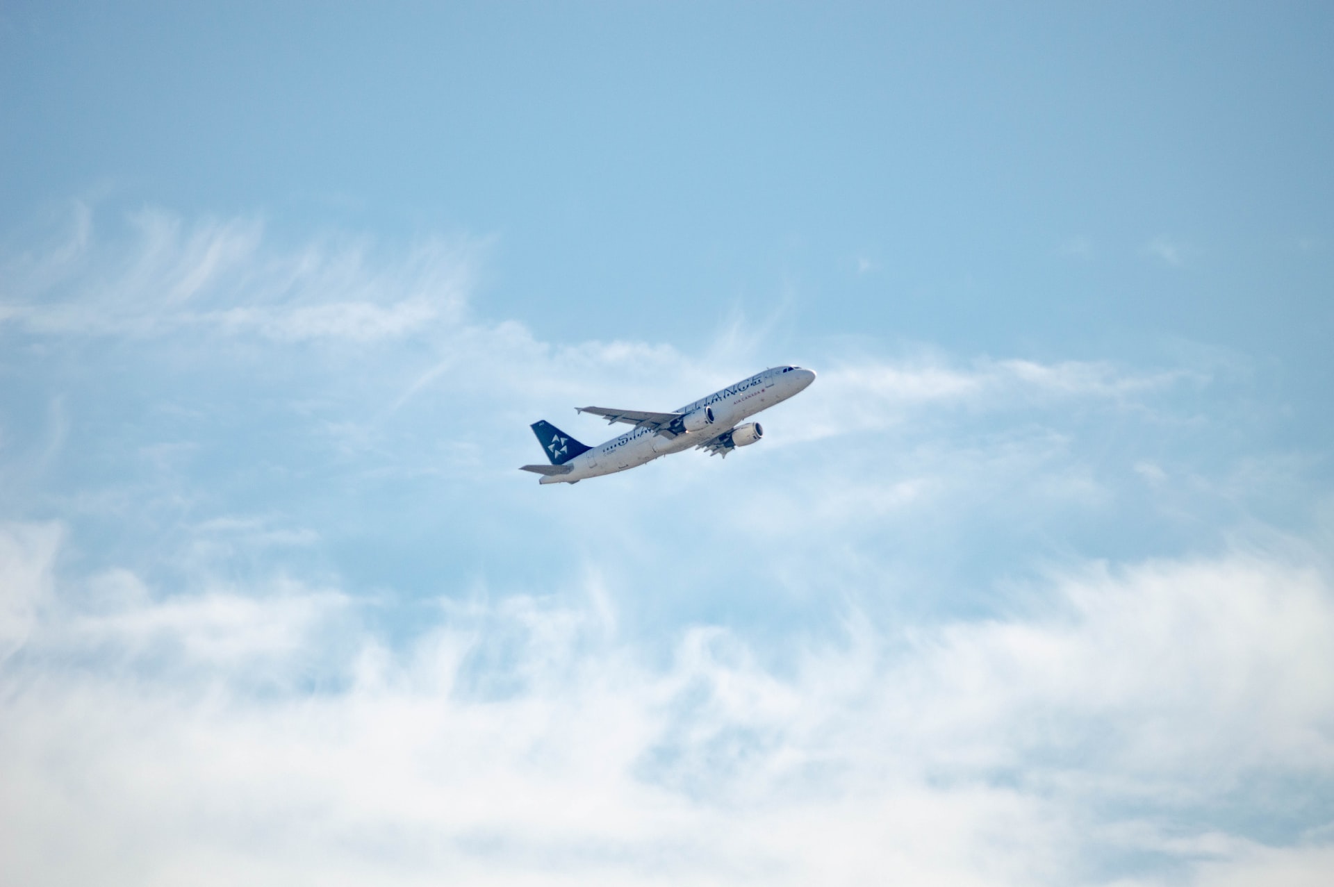 distant aircraft against a blue sky