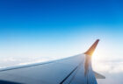 Airplane wing in flight above clouds - aerospace rivets